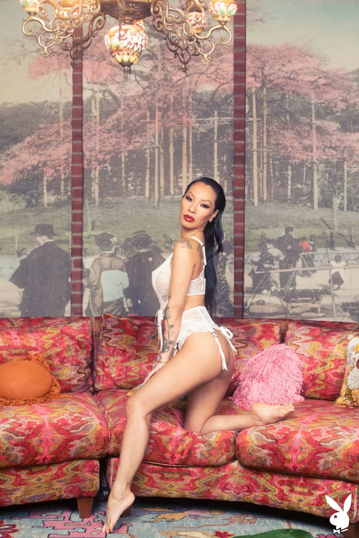 The sensual Asian MILF Asa Akira teases you while undressing herself on the couch